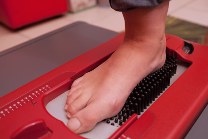 Close-up shot of foot being scanned on orthopedic device which creating a digital footstep model, helping to make perfect-fitting footwear