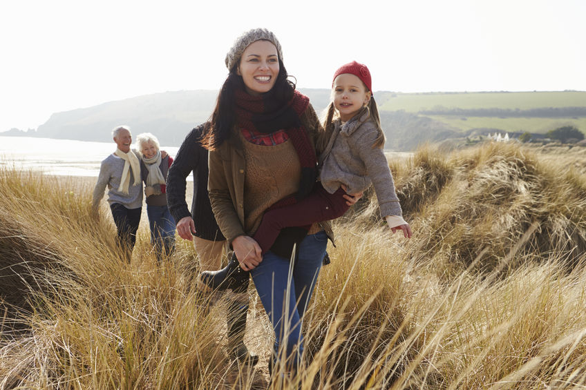 33526400 - multi generation family in sand dunes on winter beach