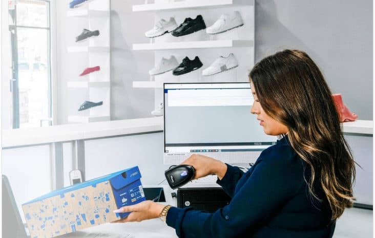 Woman Checking Customer Out