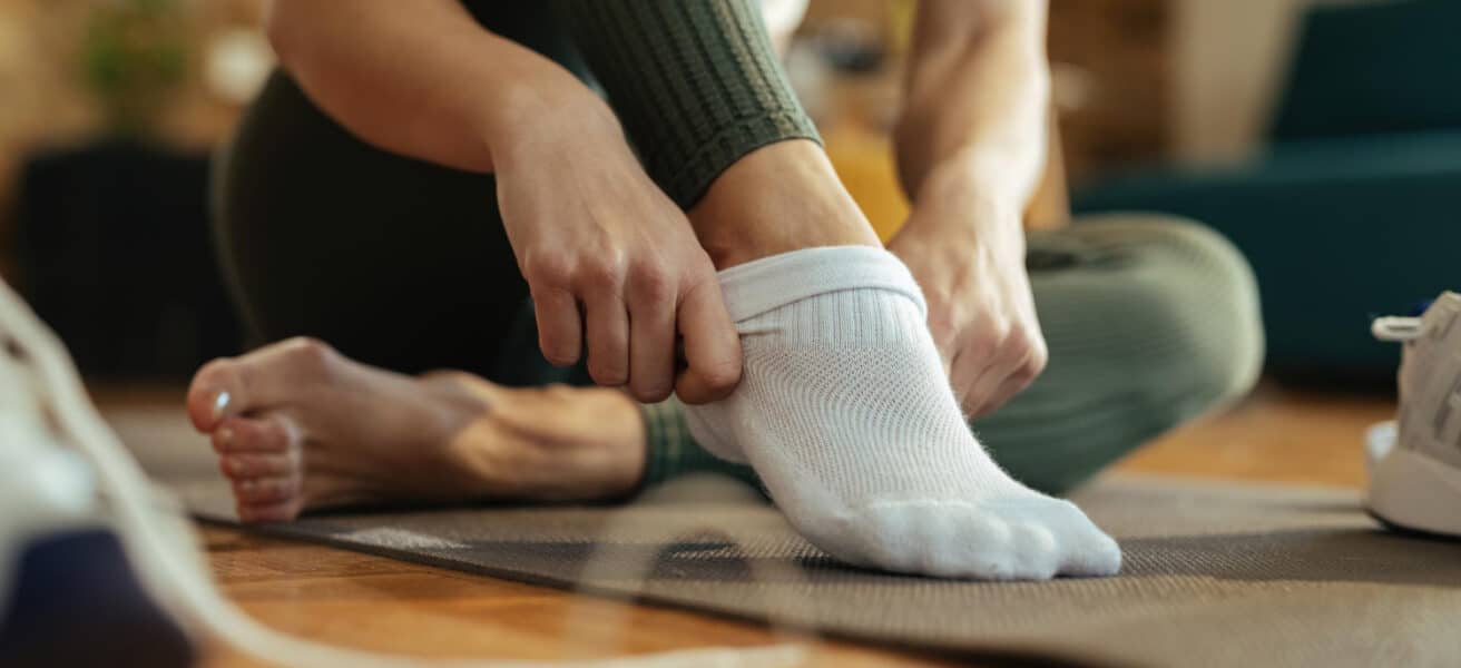 Woman putting on clean socks
