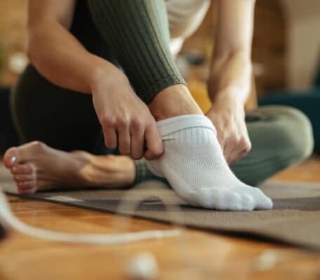 Woman putting on clean socks