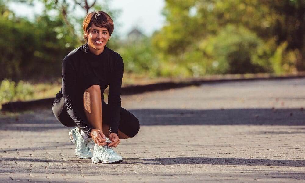 Lady putting on running shoes