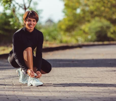 Lady putting on running shoes