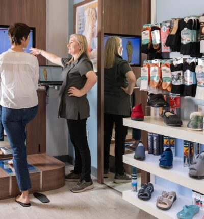 Lady having a foot scan performed at Footsolutions