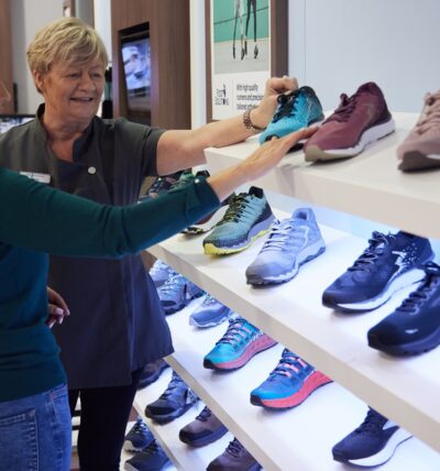 A customer looking at shoes in Footsolutions